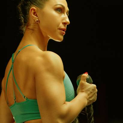 Muscular woman in gym showing back muscles. Strong fitness girl working out. Muscular woman in gym showing back muscles. Strong fitness girl working out